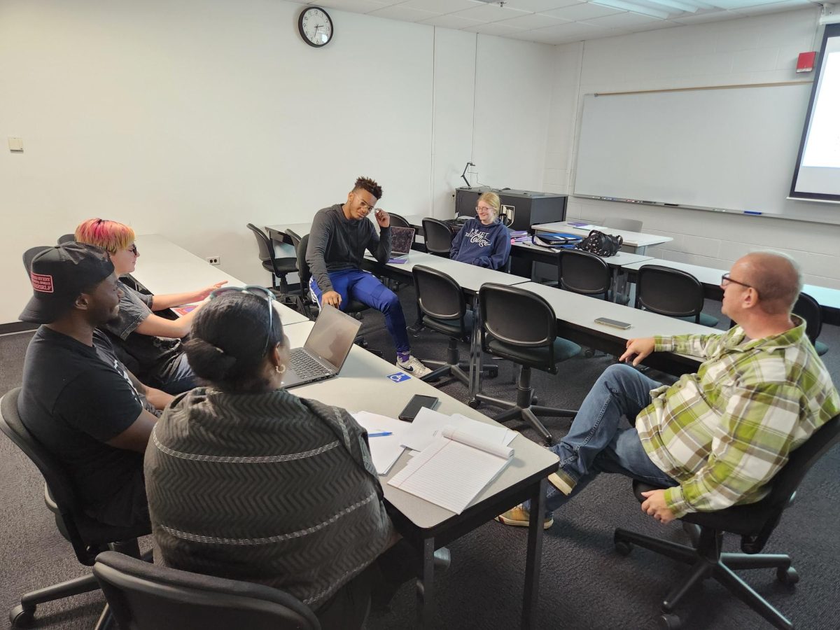 Members of the JJC Forensics Team at their weekly meeting discuss recent wins and future tournaments.