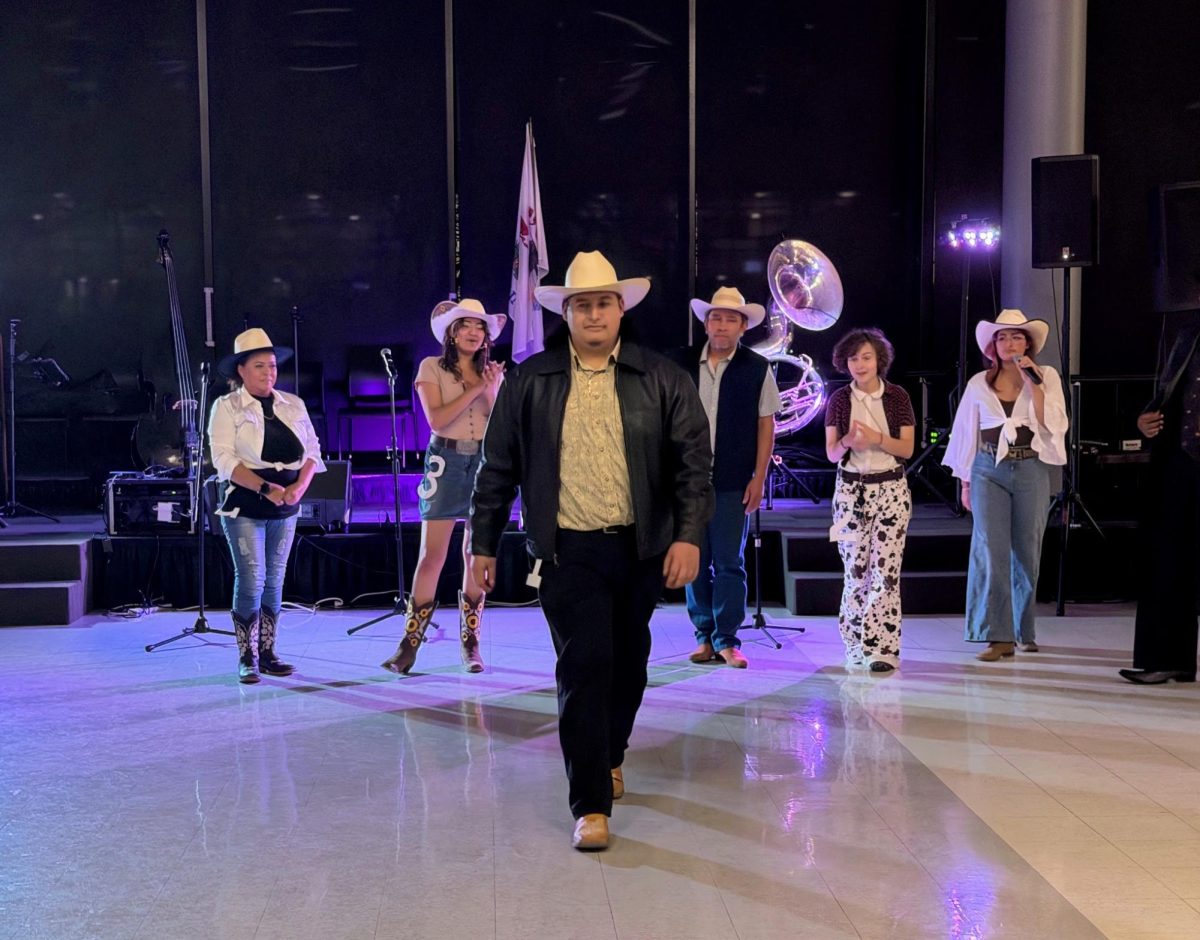 At the Vaquero Baile hosted by Latinos Unidos, Nominees of the best dressed competition walk across the dance floor as attendees cast
their vote.