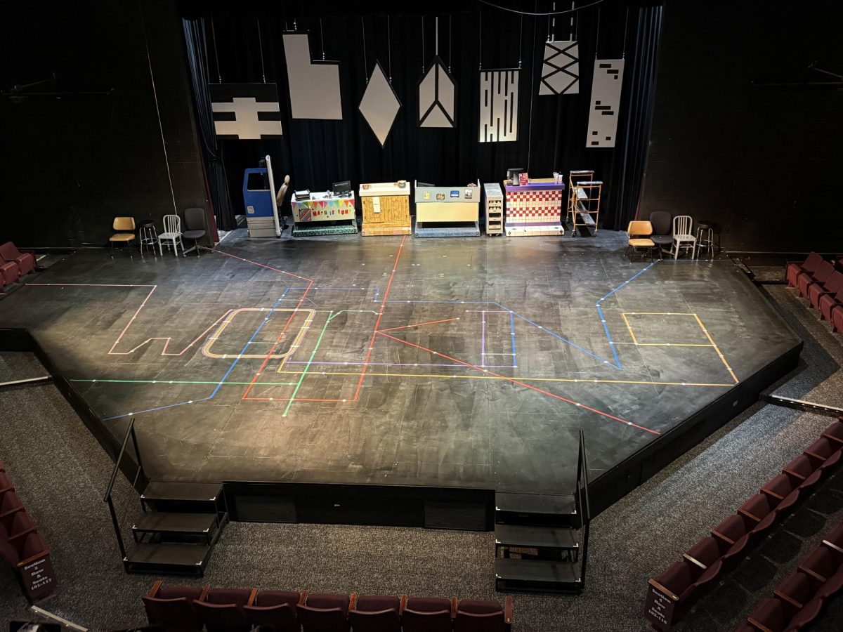 "Working" the title of the musical is placed on the floor made up of a map of certain trainlines that go through the city