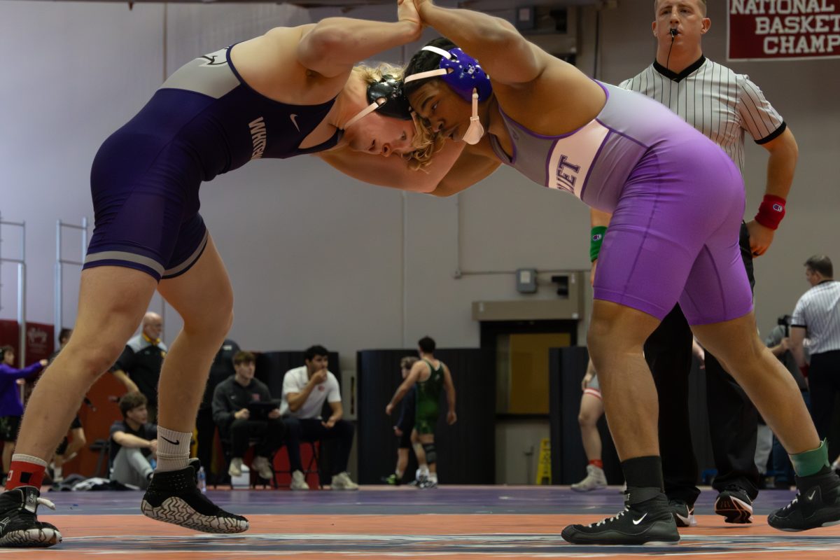 JJC Wrestler locks arms with his opponent at North Central invitational on December 13, 2025