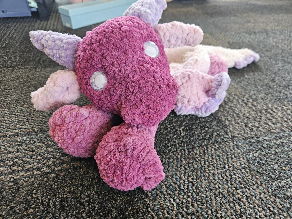 This dragon named Kato, was created by, Joliet Junior College student, Natalie Hanna. She loves to go to the Renaissance Faire, as a Dragon Princess, and "every princess needs her princess protector." In need of a protector, Hanna crocheted Kato, his dispersed weight allows for him to sit comfortably on the shoulder of whom he is protecting. 