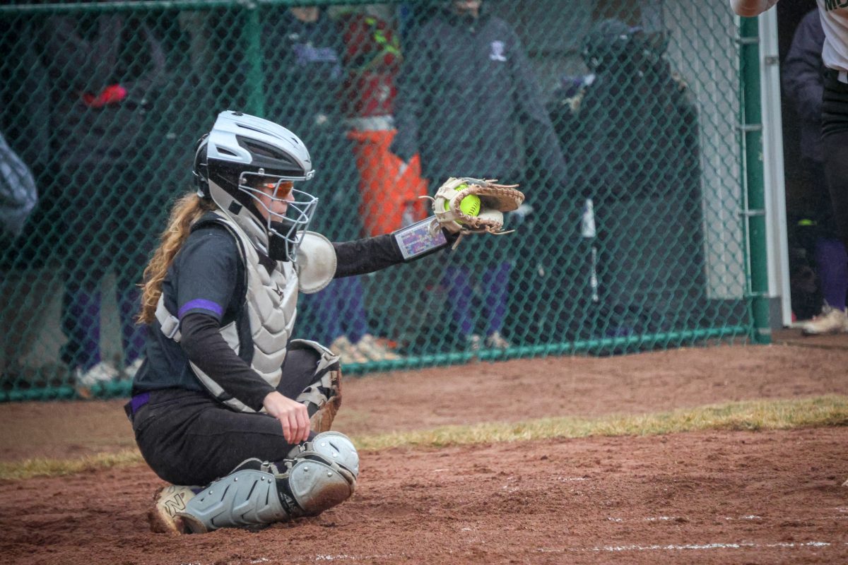 Sophomore Lea Herkel catching a pitch on March 3, 2026 against Moraine Valley. The Wolves fell short 8-4.