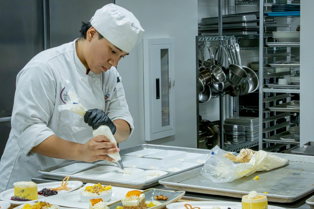 JJC culinary student garnish's a dessert at the student run restaurant Thrive on April 22, 2026.