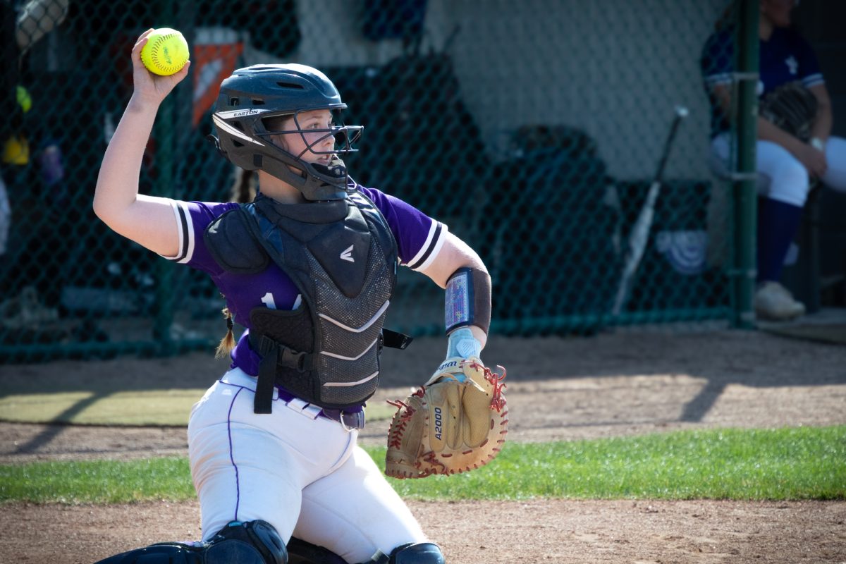 Sophomore Katelyn Dahlberg throwing the ball back to sophomore pitcher Karli McMillin against Oakton College on March 3, 2026. The Wolves took the victory 5-0.