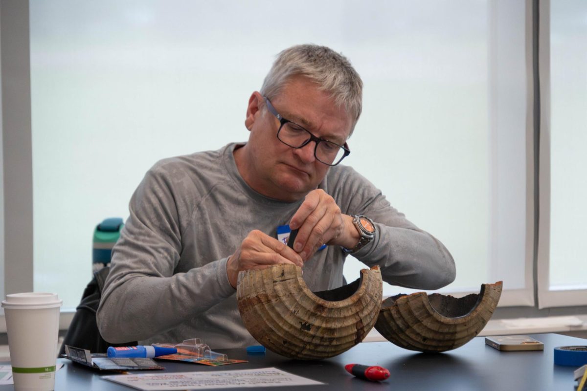 Fine arts professor Eric Gordon fixing ceramic pieces during Repair Cafe at the Romeoville campus on April 18, 2026.