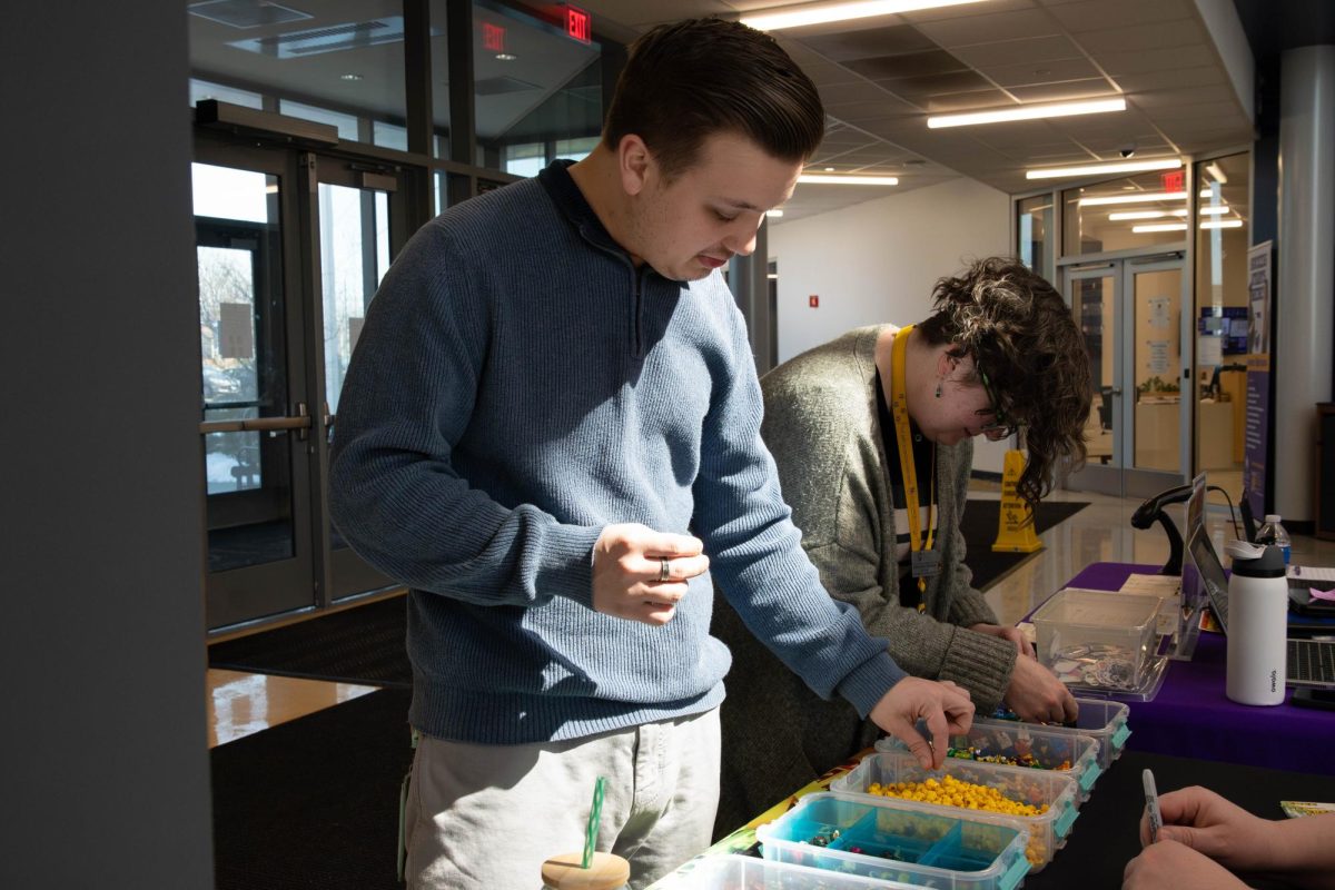 Staff member Connor Herrington and Andrea (Dre) Spreitzer building a Minifig at the "Build your own Lego Minifigure" event at the Romeoville Campus on March 18, 2026.