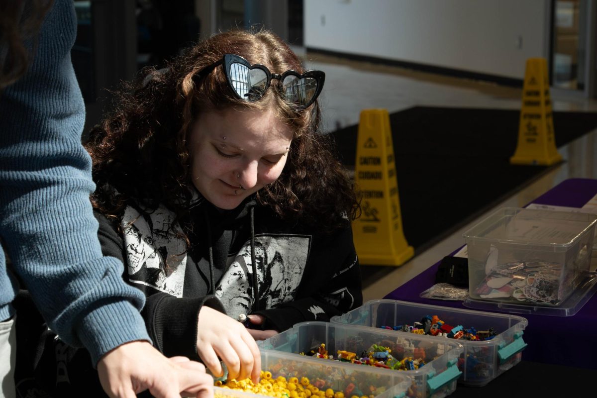 Harley Stockhausen building a Minifig at the "Build your own Lego Minifigure" event at the Romeoville Campus on March 18, 2026.
