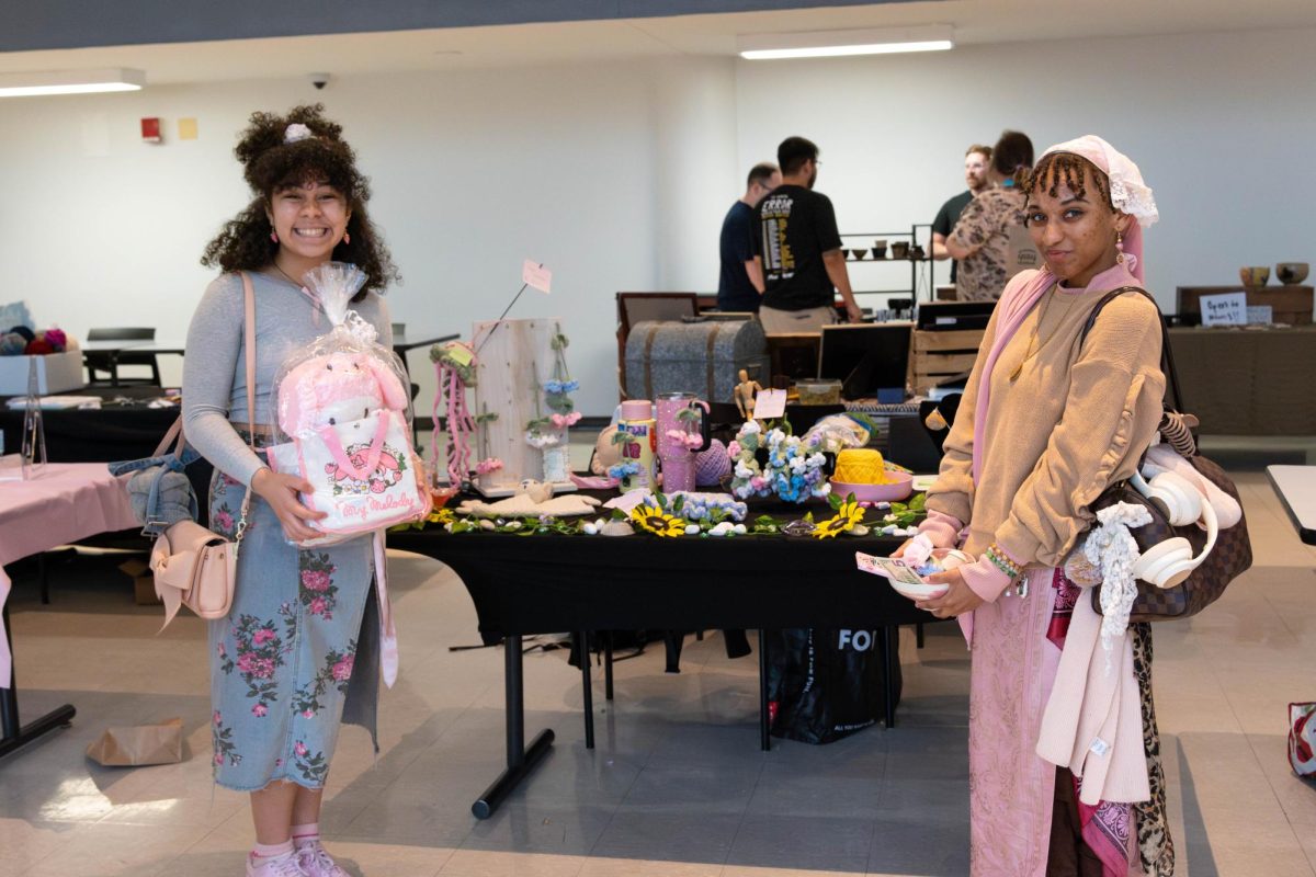 Student vendors posing in front of their table after the craft fair on Wednesday, April 22, 2026.