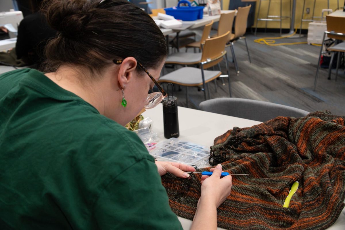 Ashley Middleton sewing during the Repair Cafe at Romeoville campus on April 18, 2026.