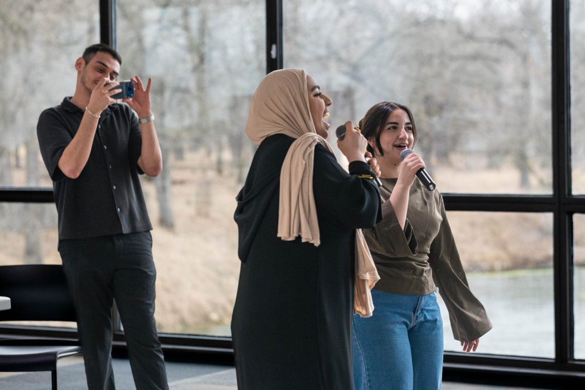 Saed Hasan filming Imane Elalamy and Hala Eid singing karaoke at the Eid al-Fitr celebration on March 26, 2026.