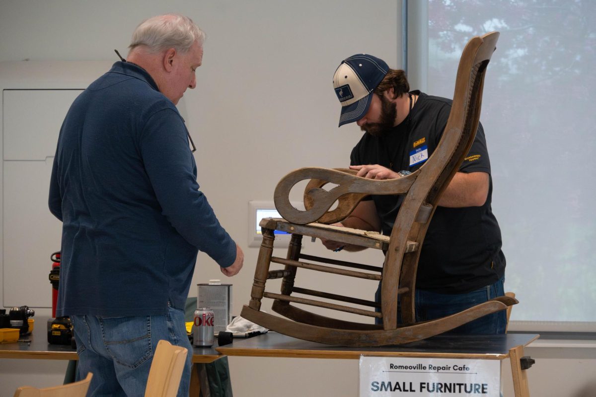 Abel Rivera and Nicholas Vaccariello fix a chair at the Repair Cafe at Romeoville campus on April 18, 2026.