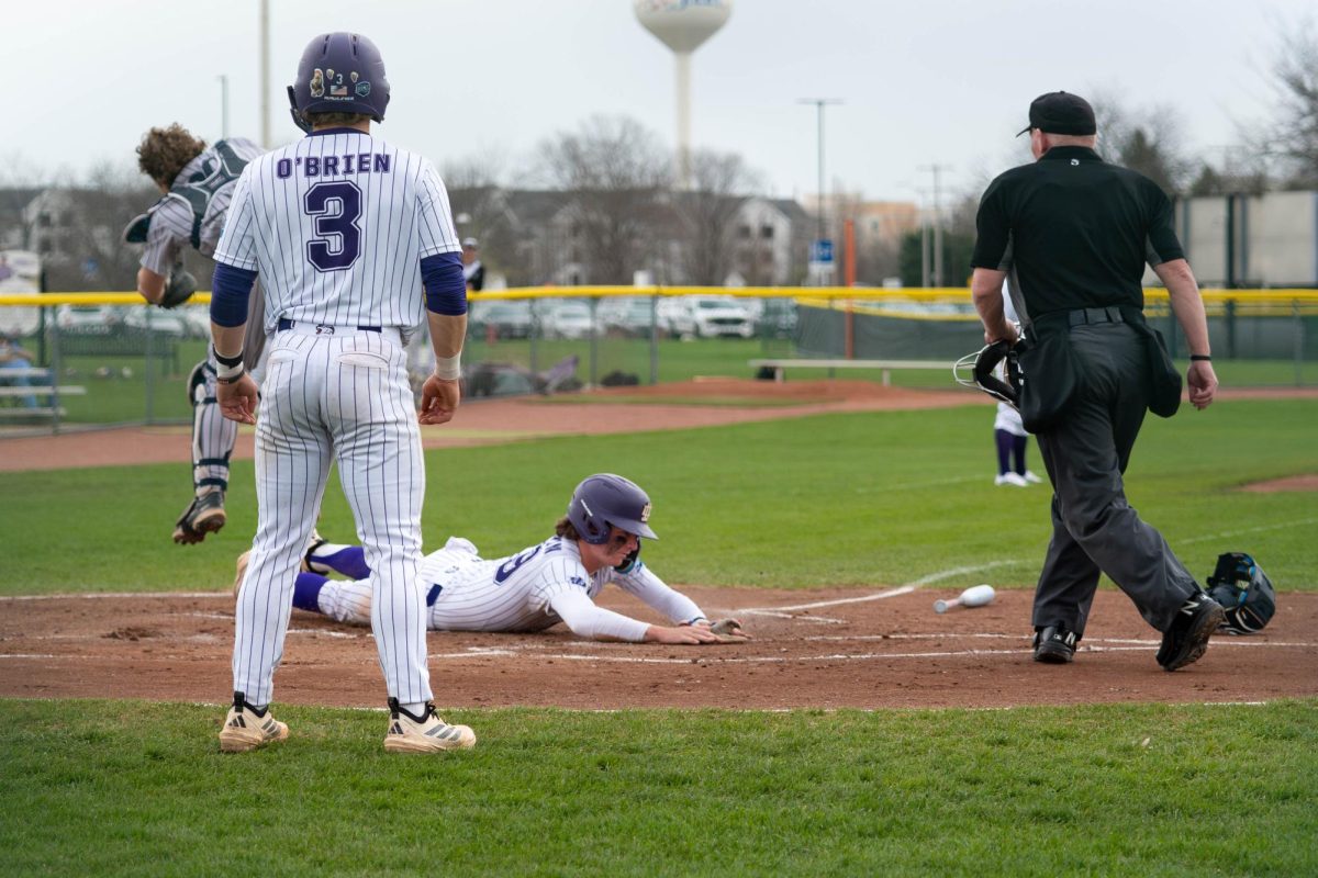 Sophomore Charlie Martin sliding into home base on Thursday, April 9, 2026 during a Baseball game against vs South Suburban College. The Wolves won 8-2.