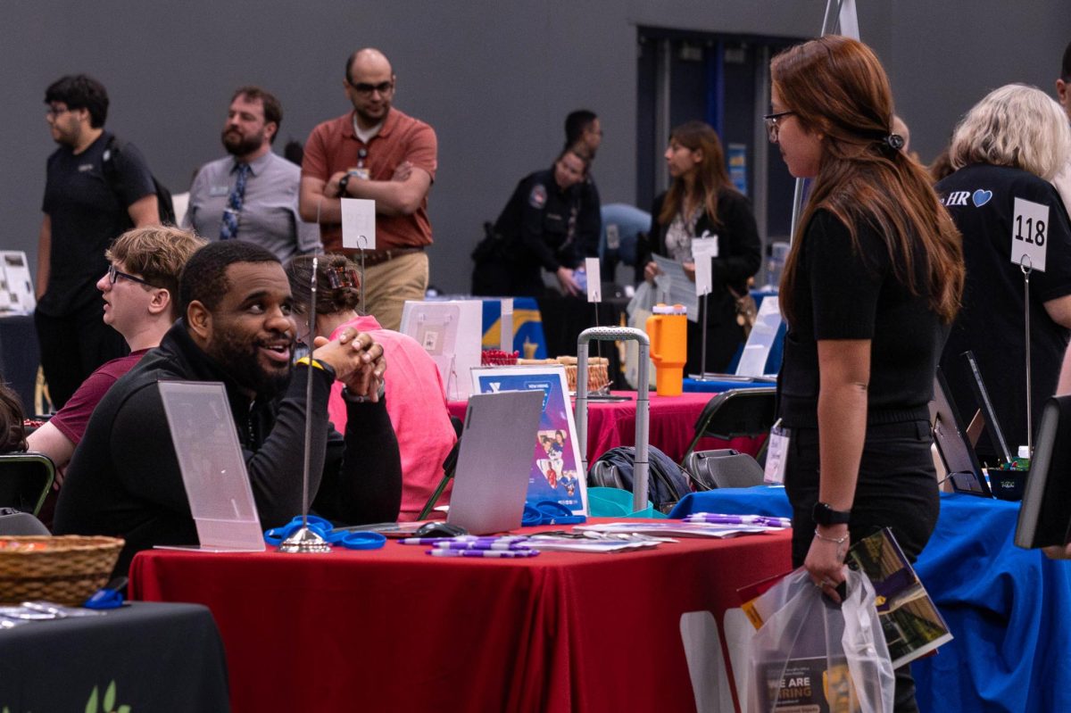 Attendee speaking with representative from YMCA at the Joliet Regional Career & College Fair on March 26, 2026.