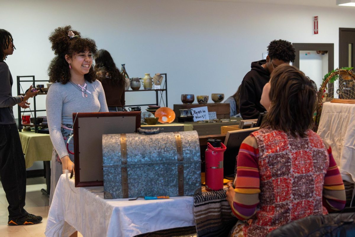 A student vendor checking out a fellow student vendors table at the craft fair on Wednesday, April 22, 2026.